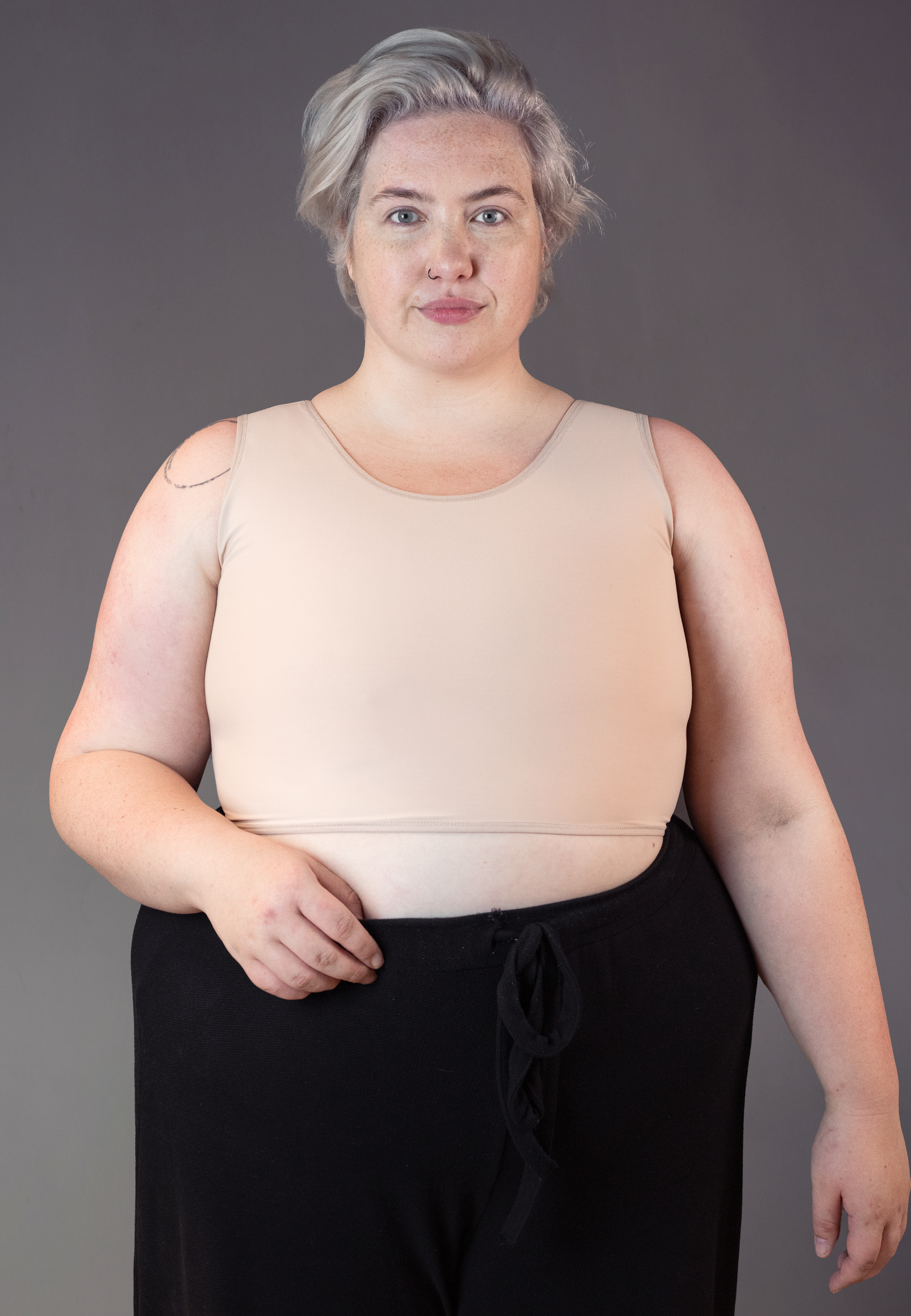 UNTAG trans masc FtM non binary short chest binder extra strong beige close up 2 front model