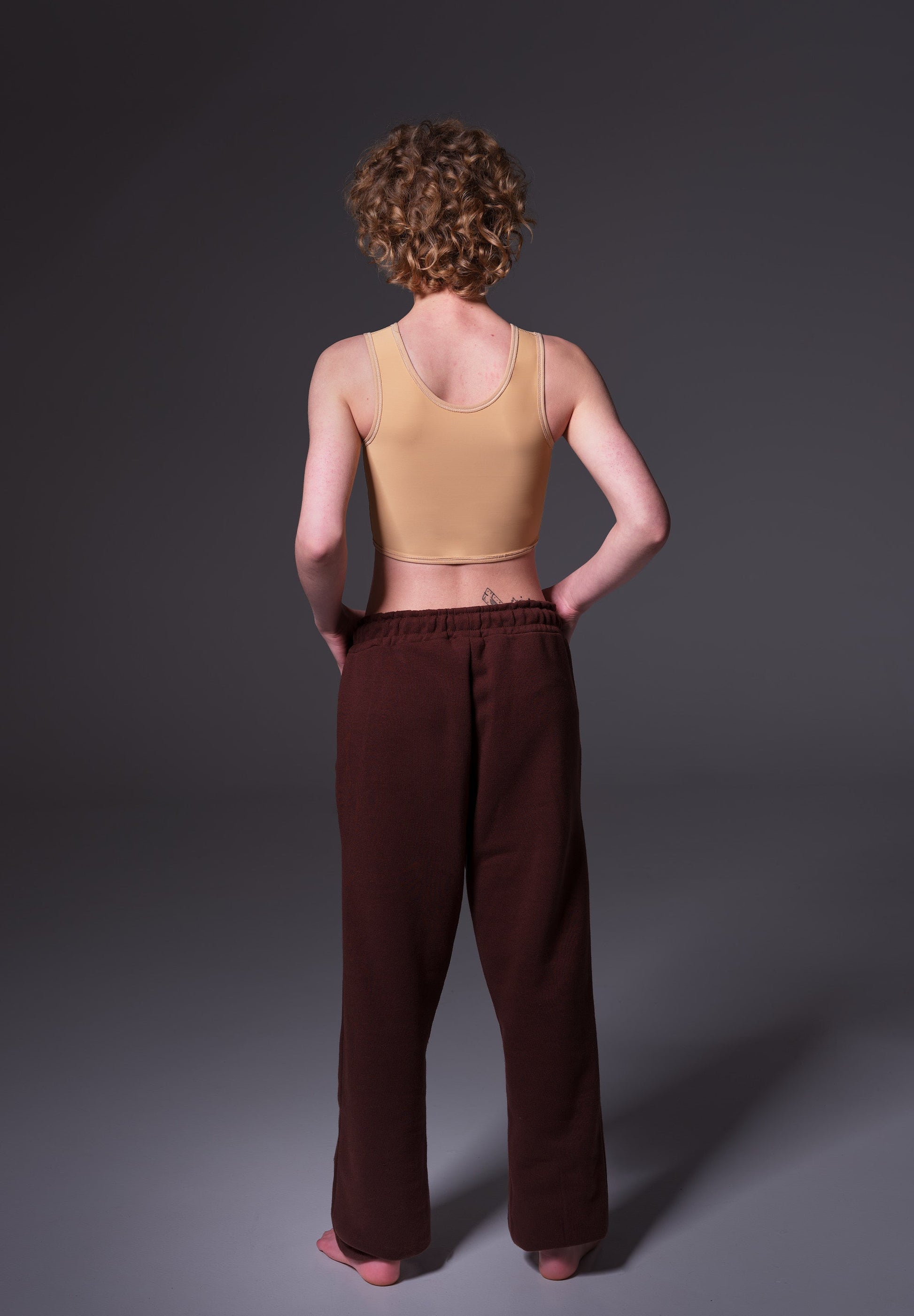 Back view of the short binder worn by Lo in the color caramel