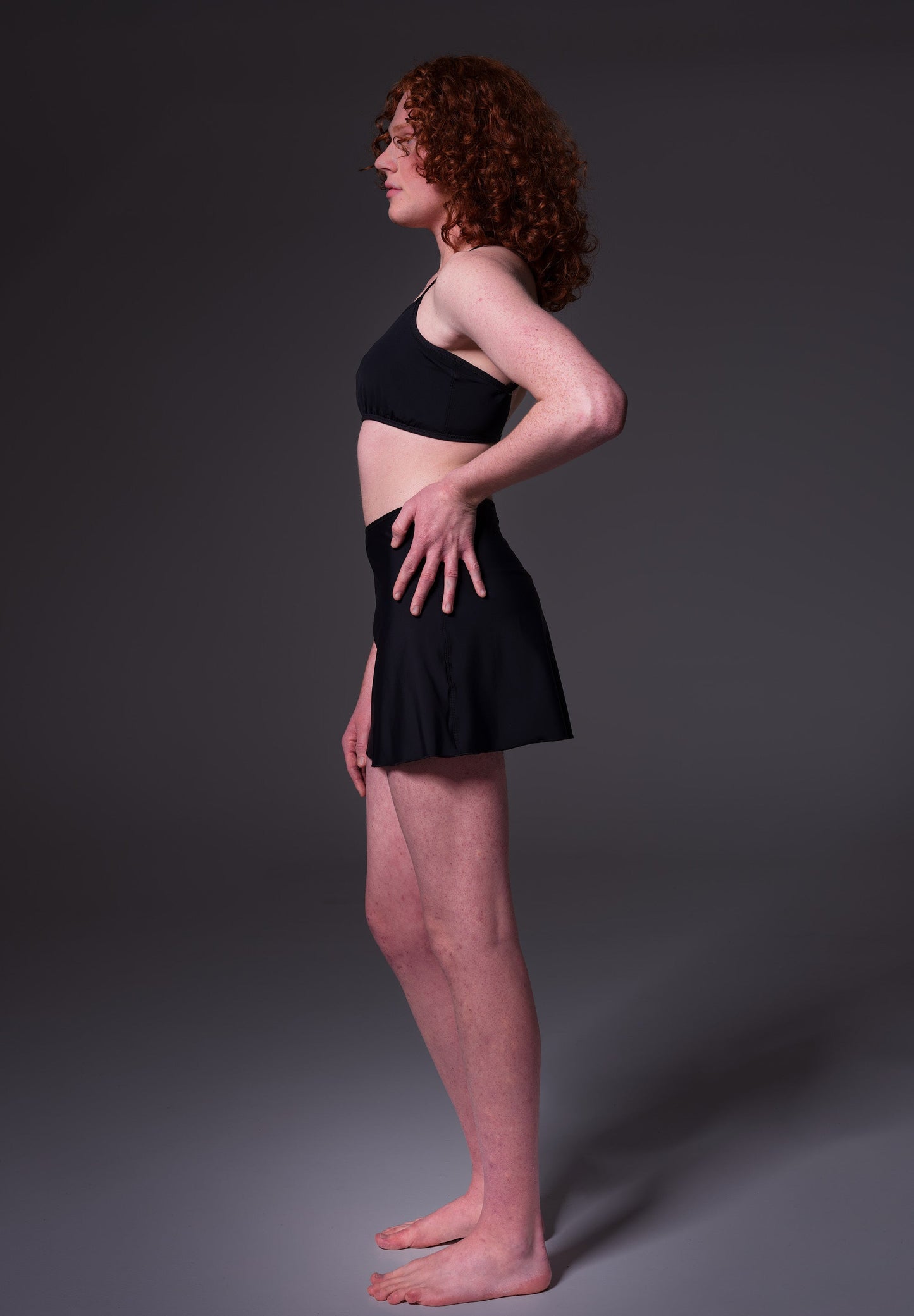Side view of Sweder, wearing the Swim Skirt black, by UNTAG